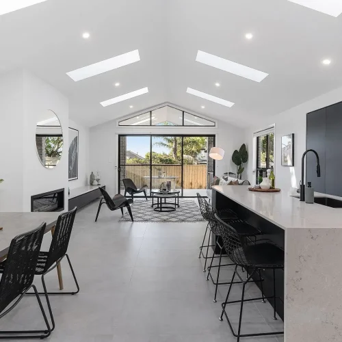 Open-plan kitchen, dining and living area with raked ceiling and skylights in a Clover Homes Kingsgrove new build